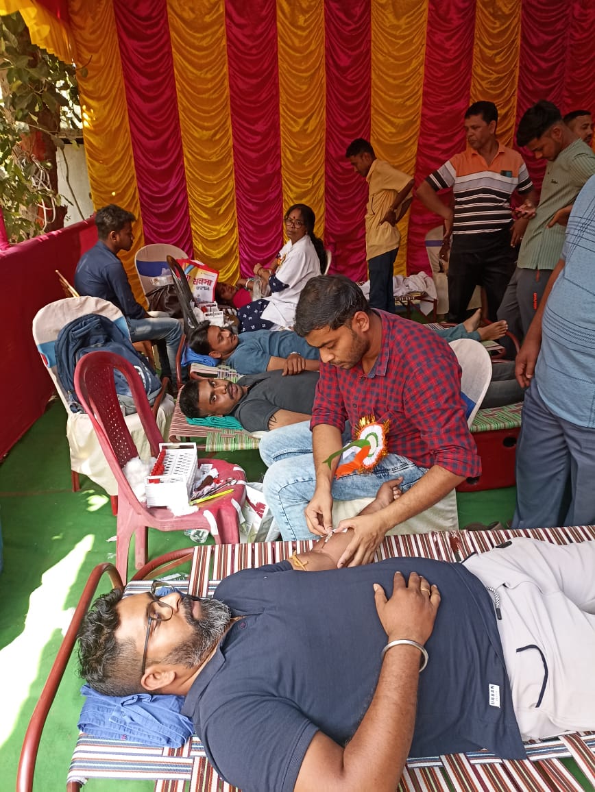 Mid-camp throughput: multiple beds running, attendants rotating. — Guma blood donation camp