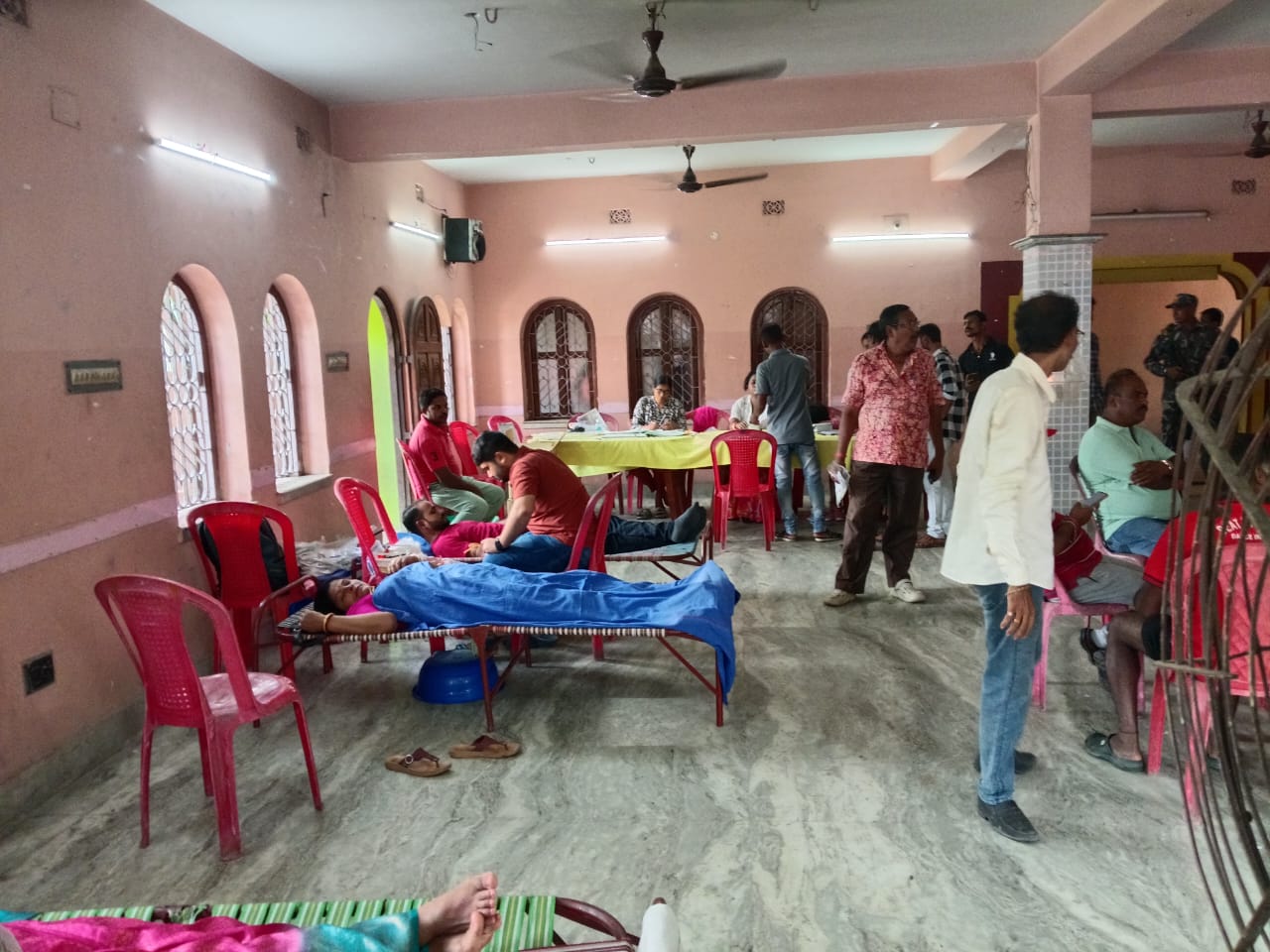 Familiar scene by mid-morning — beds full, technicians moving between them. — Duttapukur blood donation camp