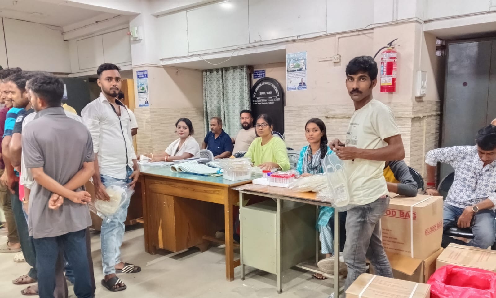 Quiet stretch of the camp — three beds in parallel, all running smoothly. — Habra blood donation camp