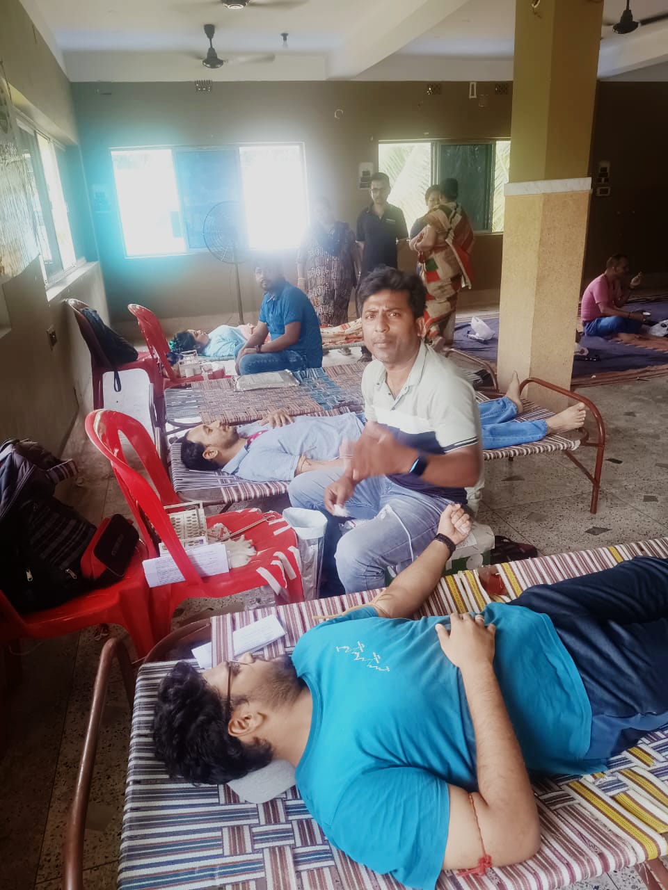 Phlebotomist prepping the arm — antiseptic wipe, vein found. — Hridaypur blood donation camp