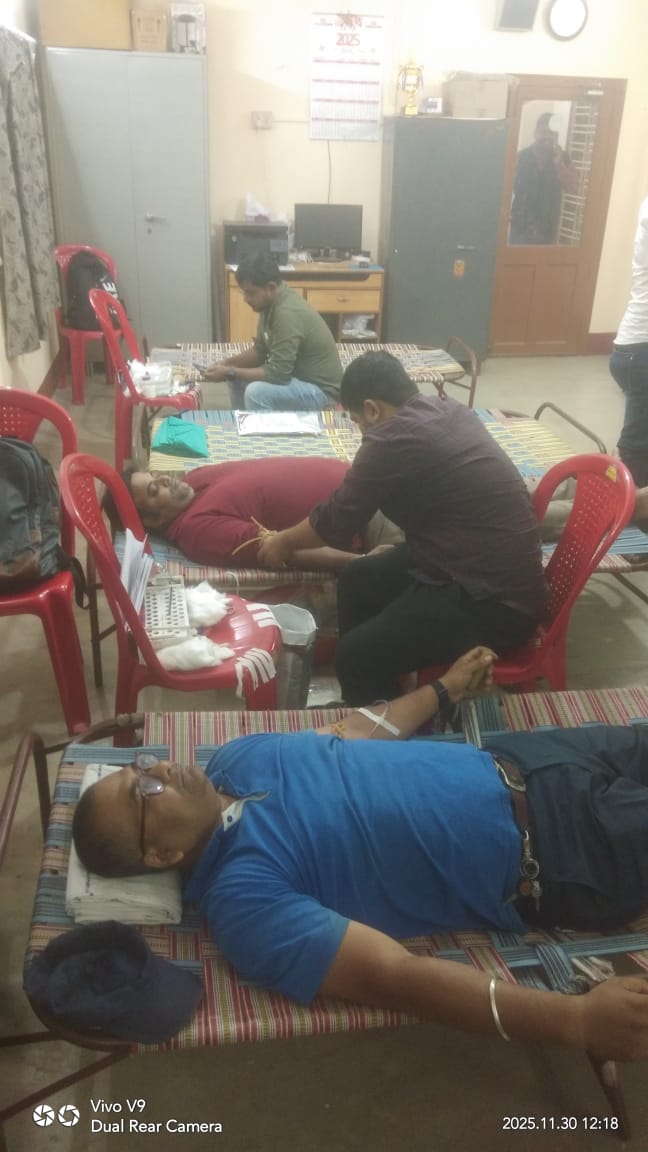Volunteer settling in for the draw, team checking tube clamp and flow. — Ranaghat blood donation camp