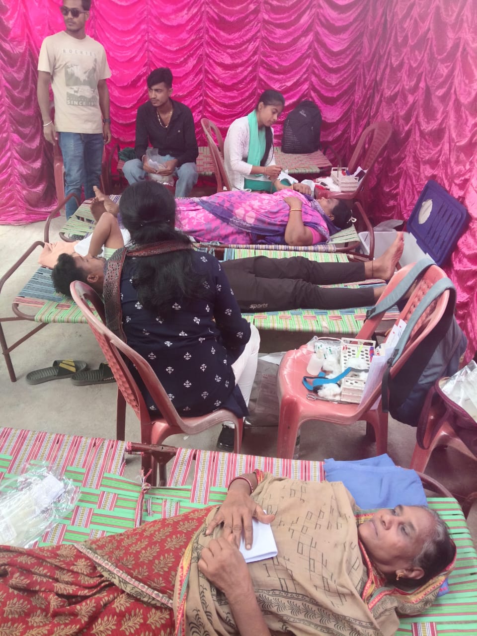 Mid-camp throughput: multiple beds running, attendants rotating. — Ranaghat blood donation camp