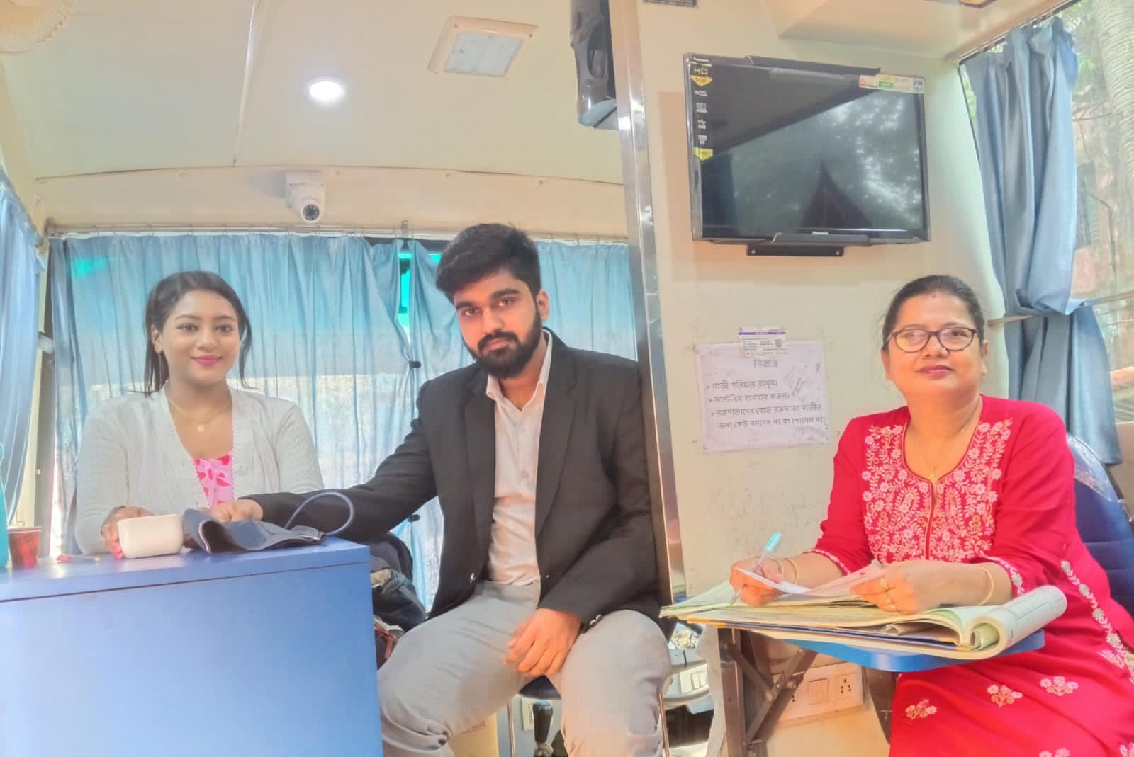 Mid-camp throughput: multiple beds running, attendants rotating. — Chakla blood donation camp
