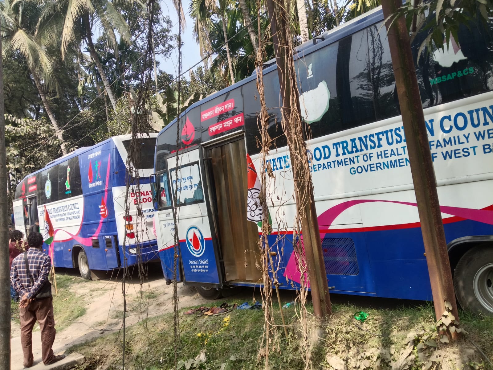 Familiar scene by mid-morning — beds full, technicians moving between them. — Deganga blood donation camp