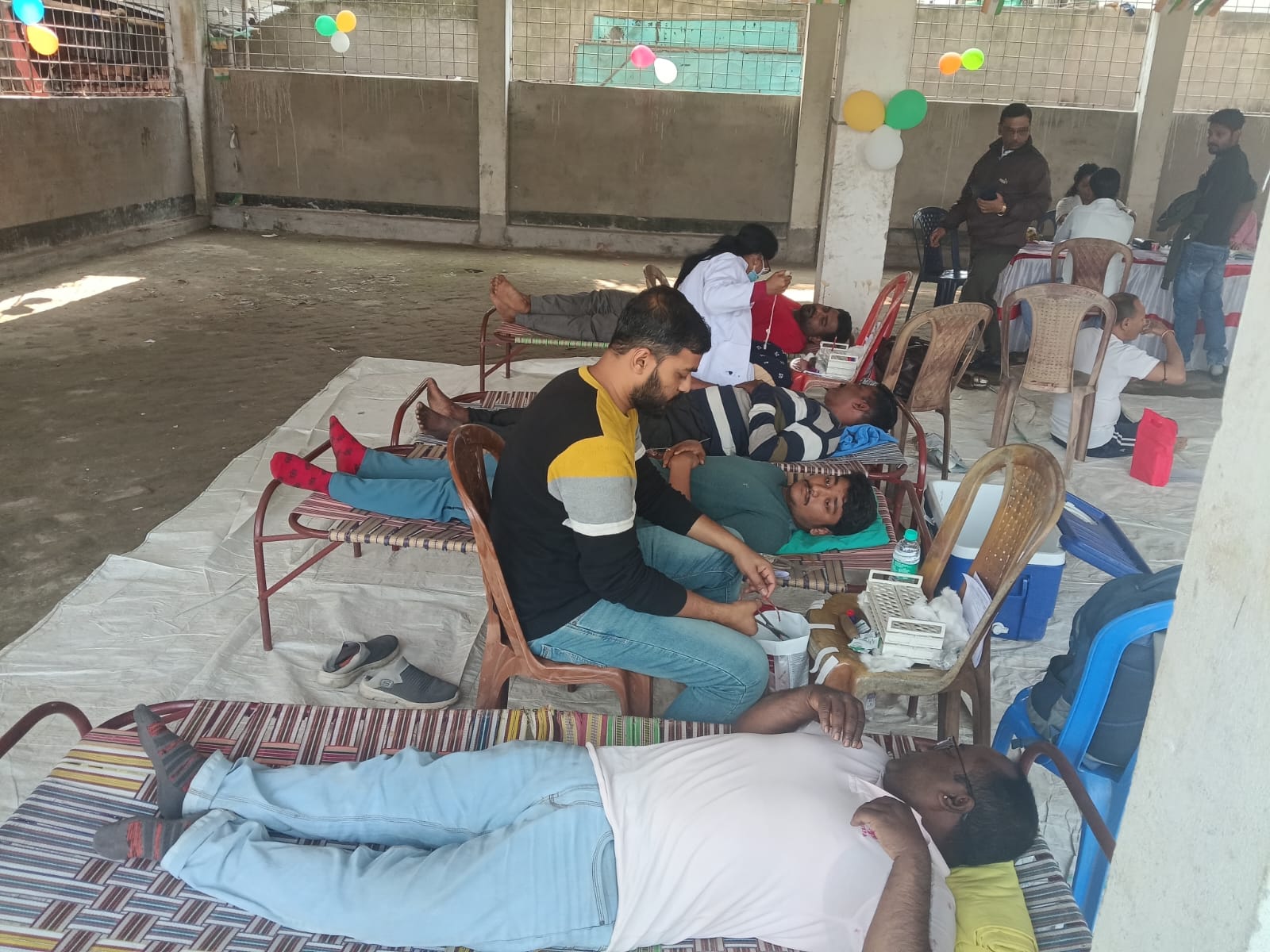 Phlebotomist prepping the arm — antiseptic wipe, vein found. — Deganga blood donation camp