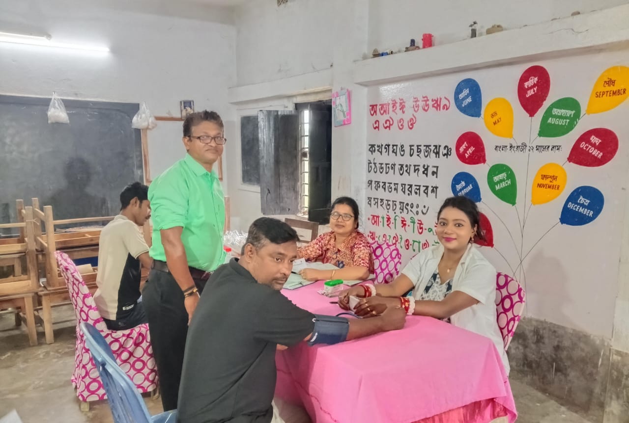 Mid-camp throughput: multiple beds running, attendants rotating. — Bira blood donation camp