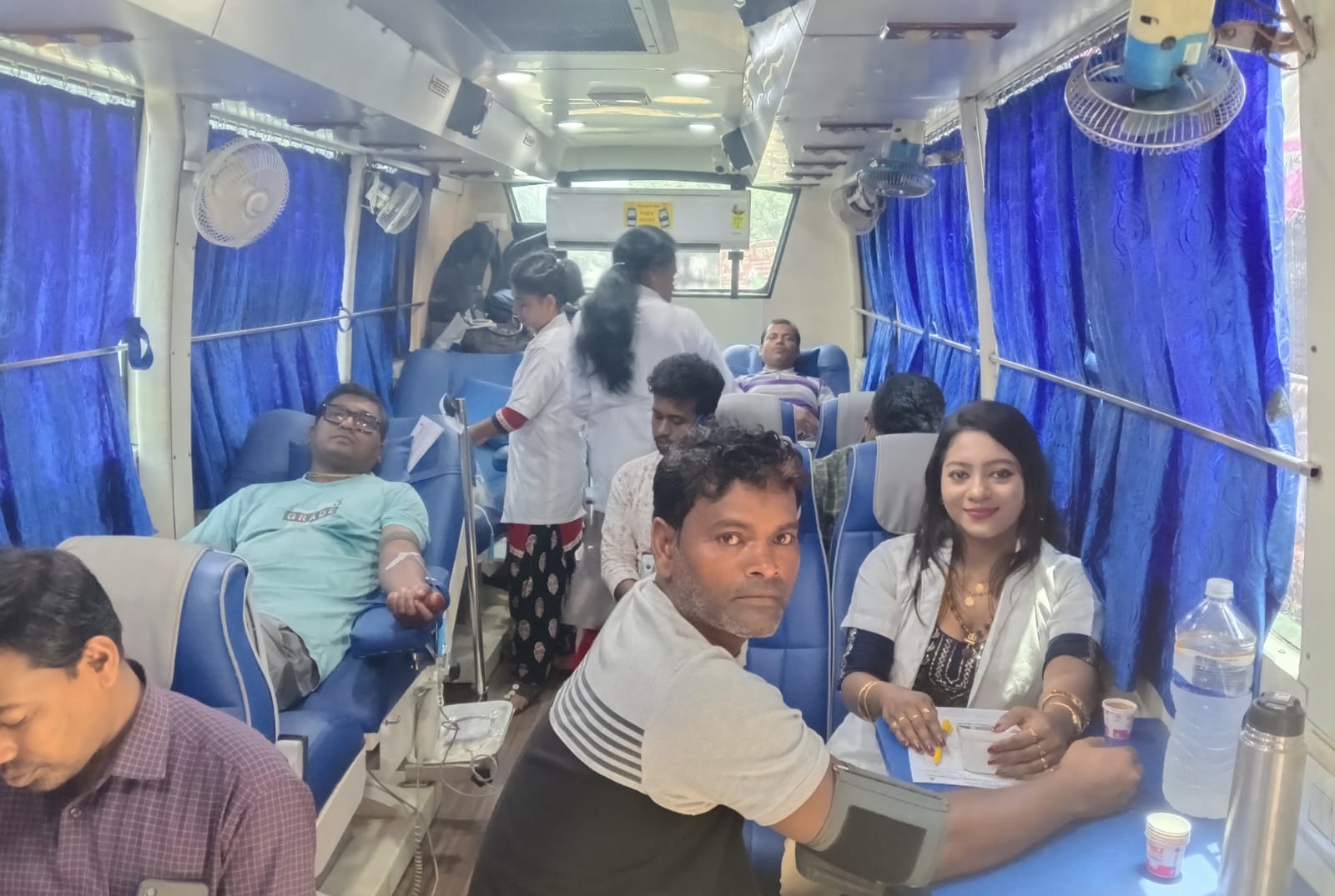 Quick anemia + obesity screen on the SamaBeat clip — passes the donor through to the bed if cleared. — Deganga blood donation camp